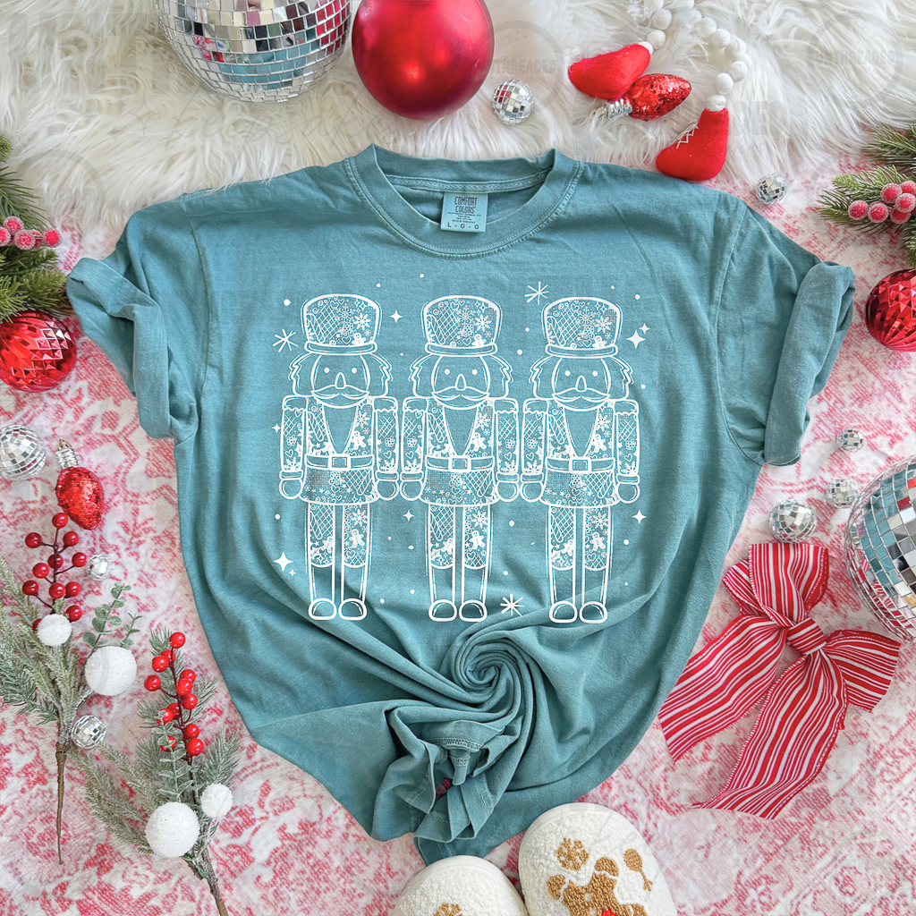 Blue teal Christmas nutcracker trio graphic tee