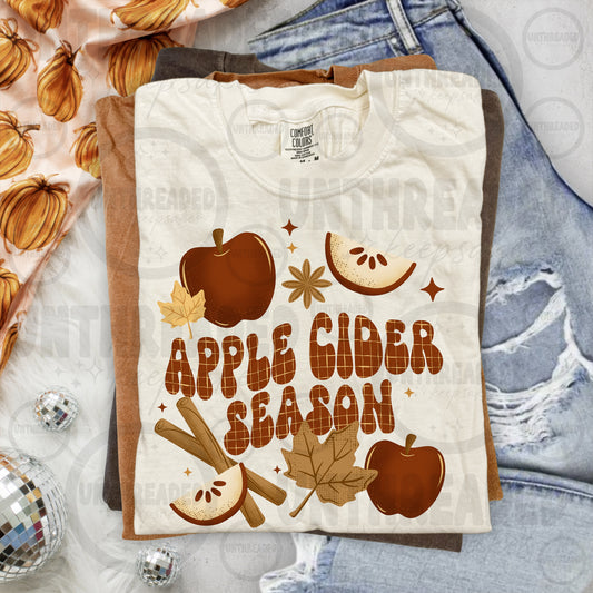 Apple Cider Season graphic T-shirt mockup with apples, cinnamon, and leaves