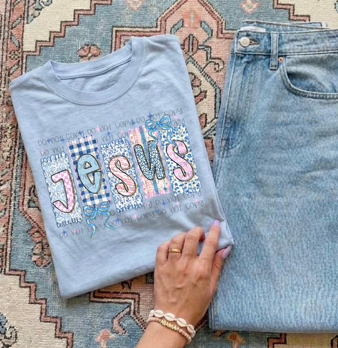 Light blue Jesus patchwork graphic T-shirt with blue bows and pink accents