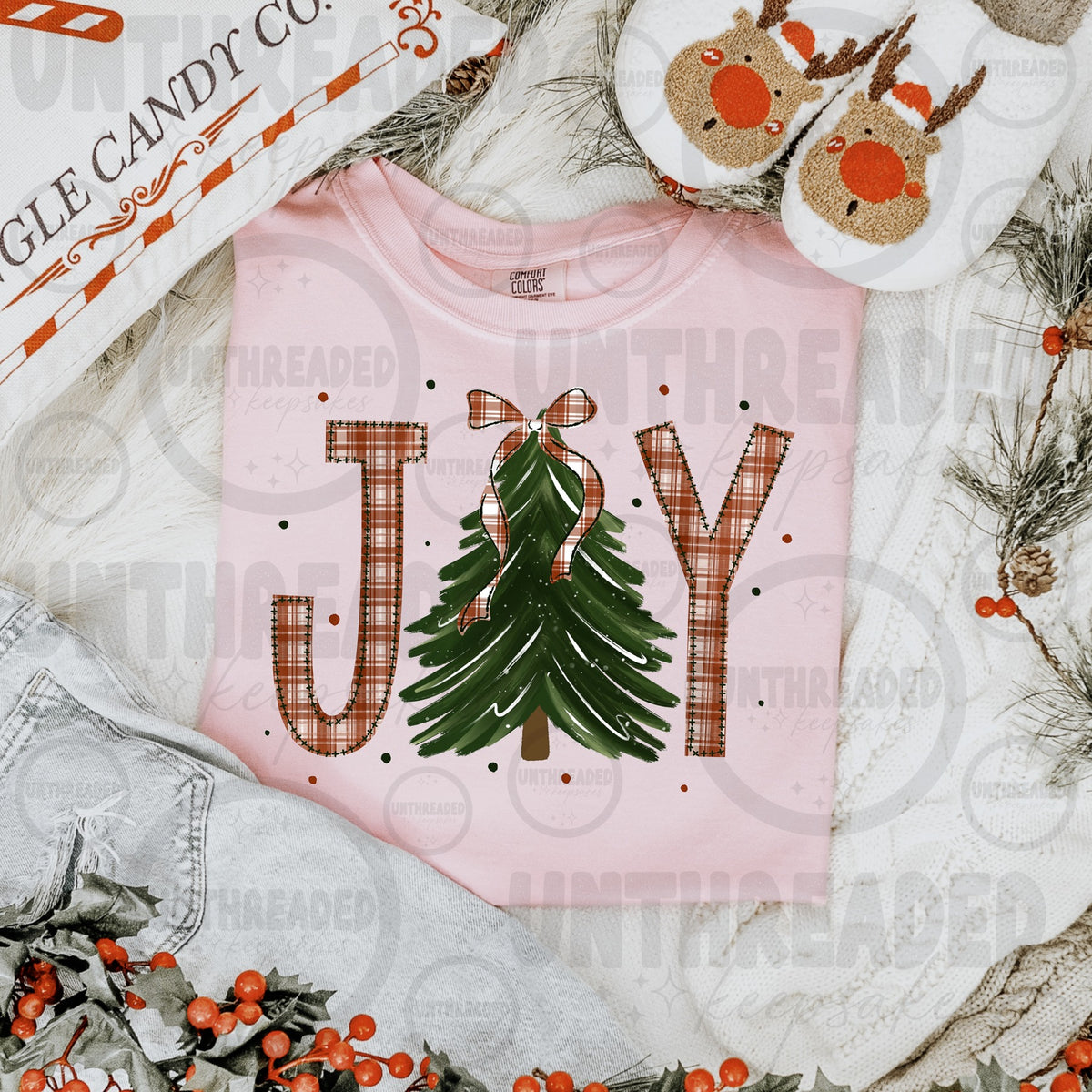 Pink T-shirt with JOY lettering, red plaid letters, green Christmas tree and bow