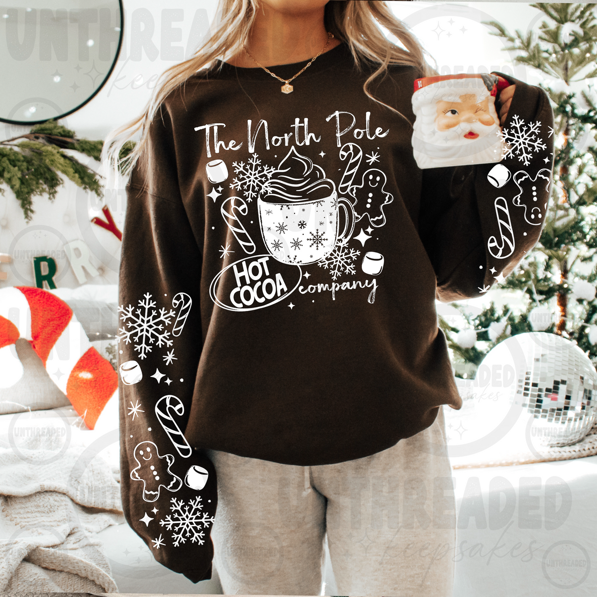 North Pole Hot Cocoa Company Christmas crewneck on brown