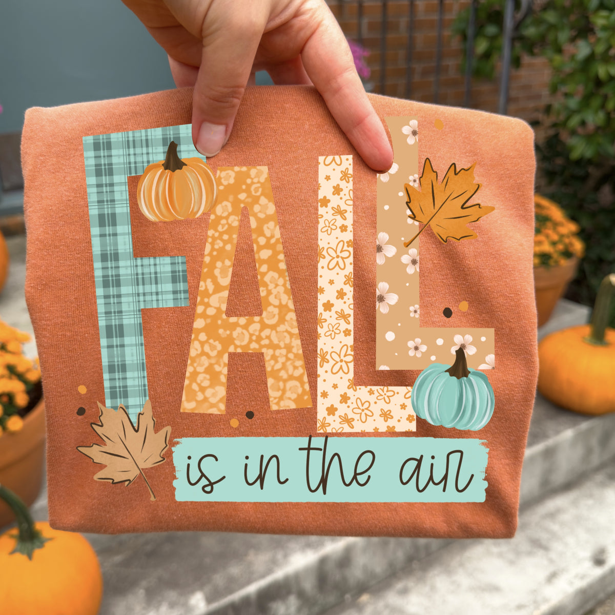 Orange Fall Is in the Air Patchwork Letters and Pumpkins Graphic T-Shirt mockup