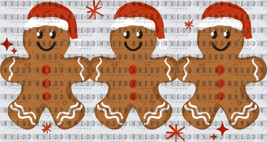 Three Smiling Gingerbread Men in Santa Hats with Snowflakes